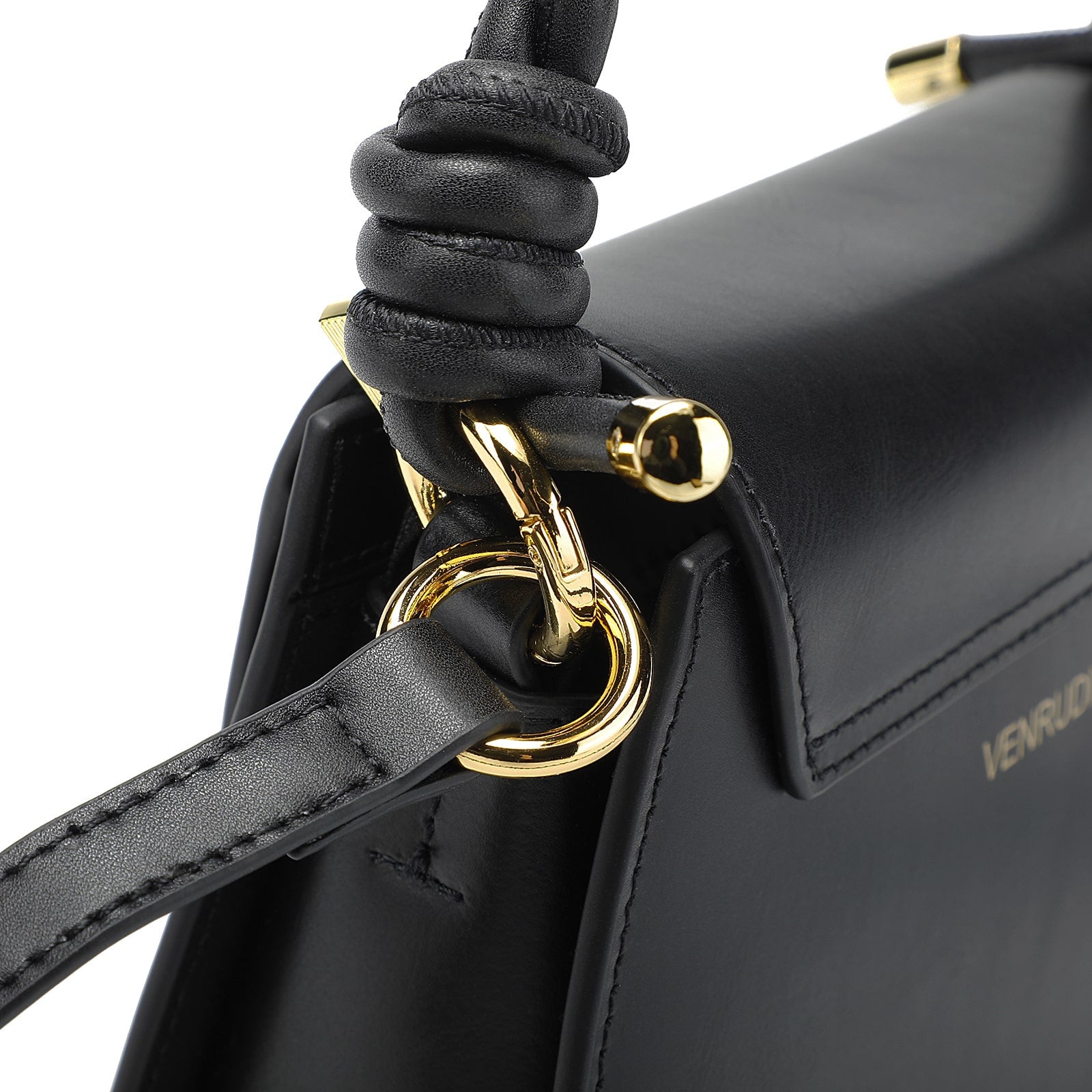 Black handbag with gold clasp and sculpted knot handle detail and subtle logo.