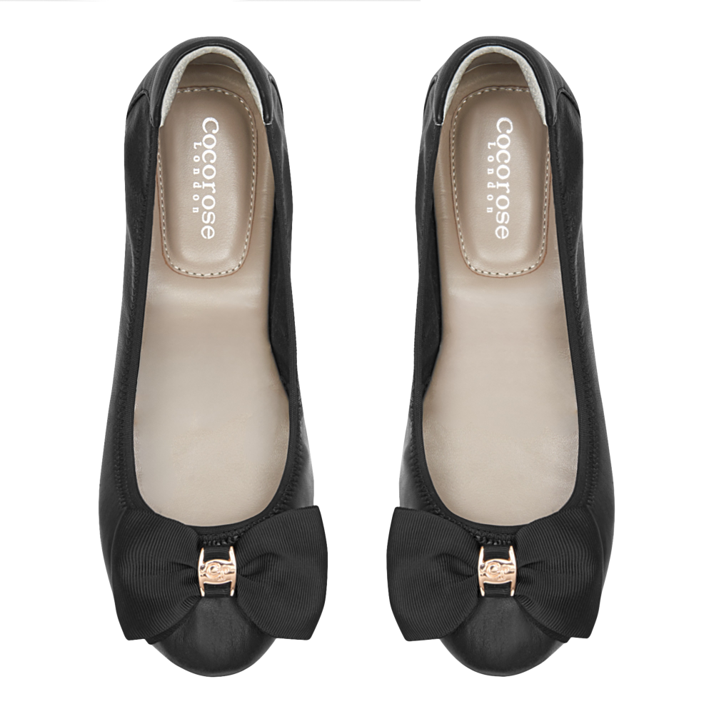 Black Leather Ballerina shoe with black grosgrain bow, soft insole and relaxed upper - by Cocorose London. On white back ground
