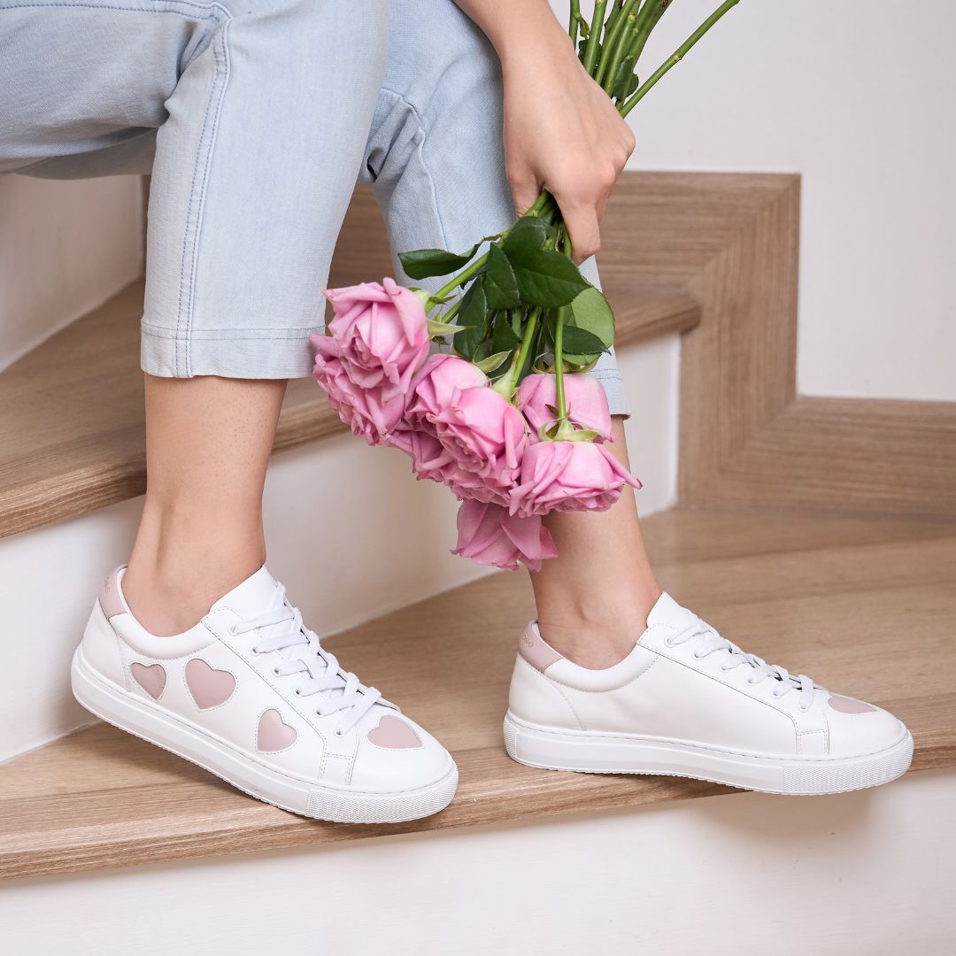 white leather trainers with pastel pink hearts