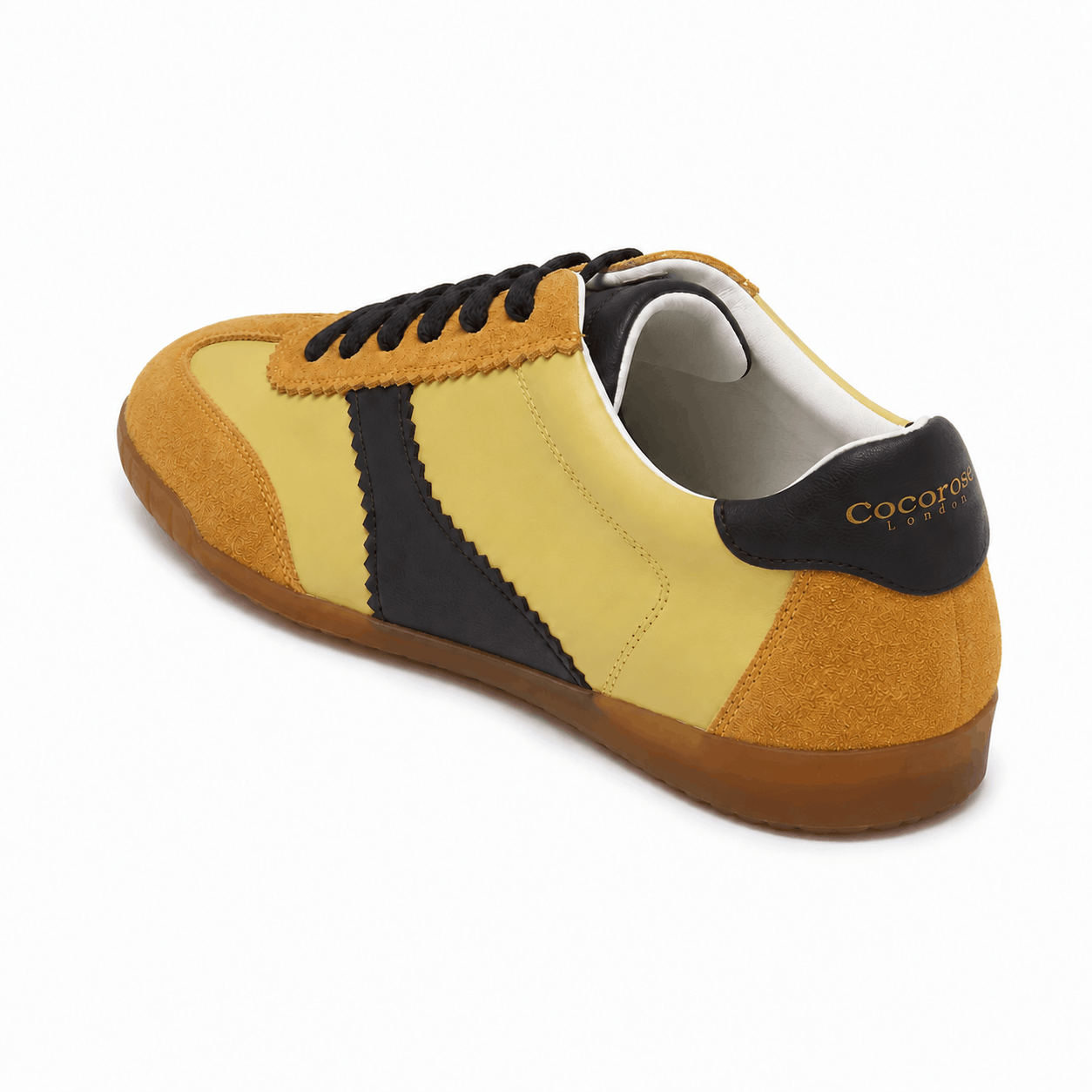 Yellow leather and suede sneakers with chocolate brown accents on a white background