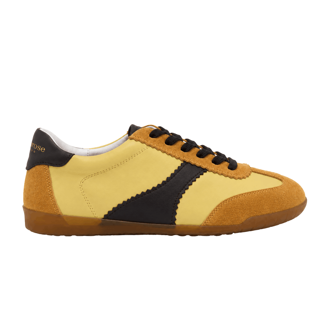 Pair of yellow and chocolate brown leather sneakers on a white background