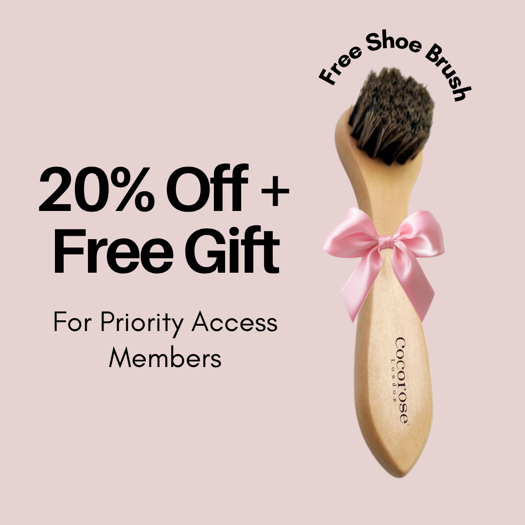 Wooden shoe brush with a pink bow on a light pink background, promotional text for 20% off and free gift.