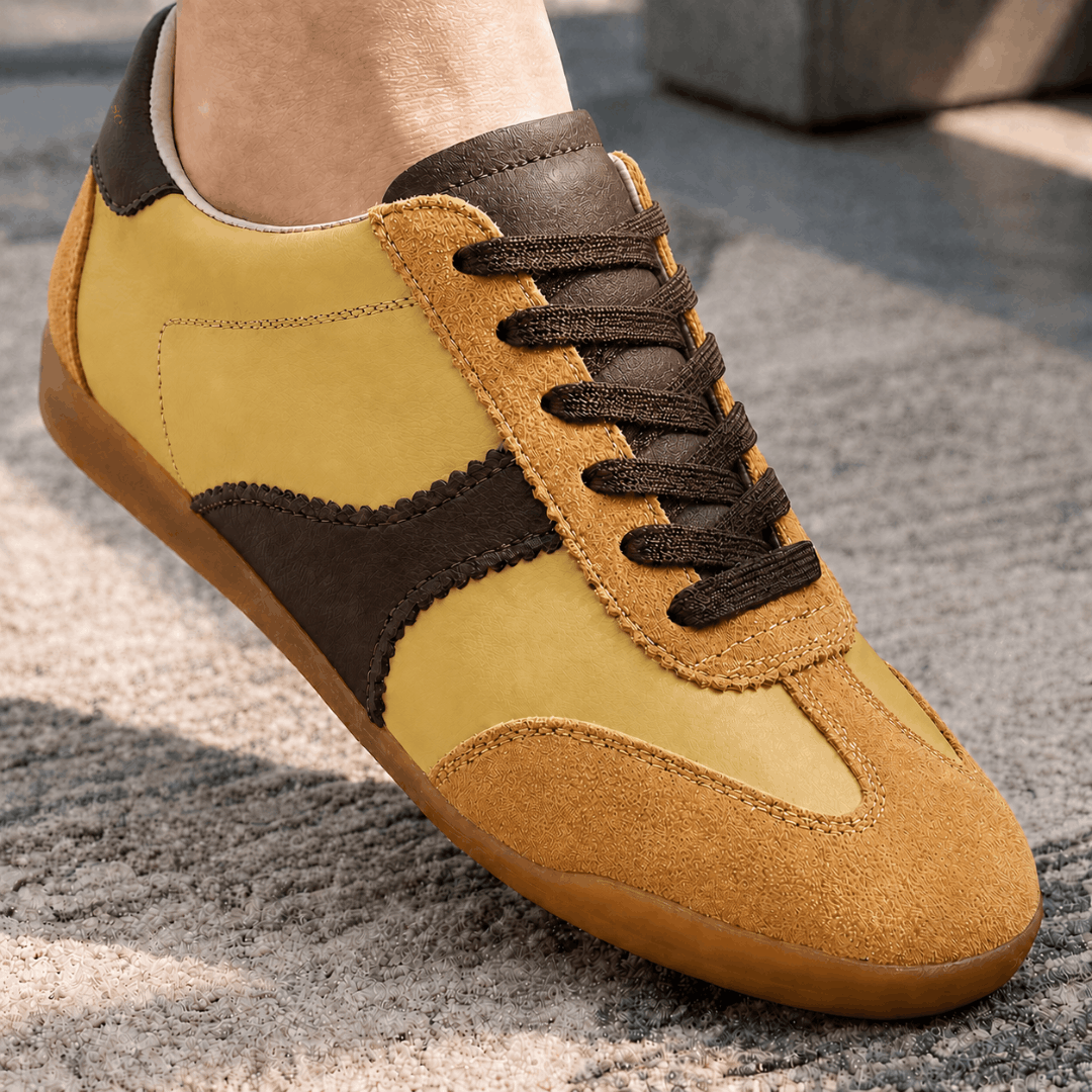 A close up look of yellow and chocolate brown low-top trainers