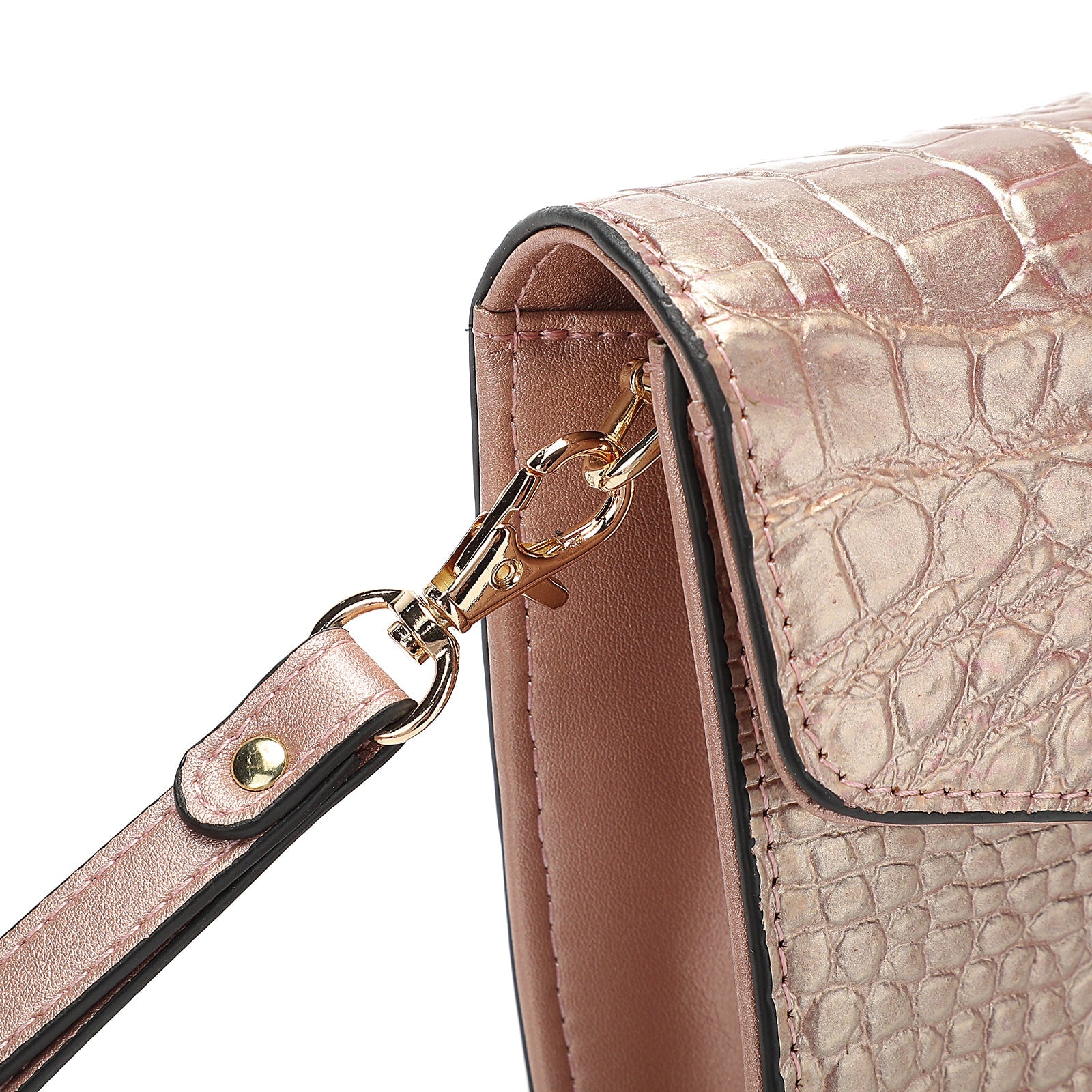 Close-up of a pink crocodile-patterned handbag with a gold clasp on a white background