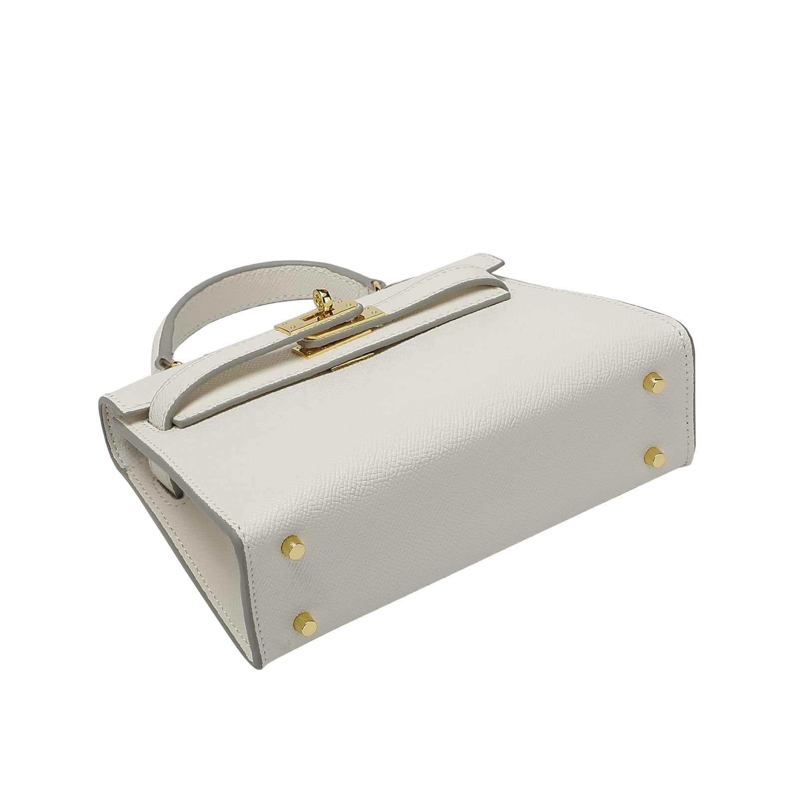 Picture shows four gold hardware studs on the base of a white leather handbag on a white background
