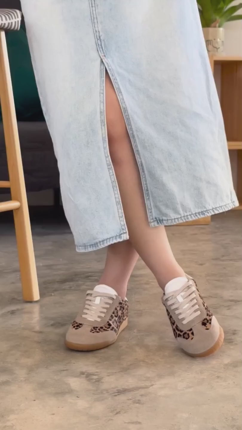 Video of woman wearing denim midi skirt and Moorgate leopard print trainers with beige suede trim and showing off her leather sneakers