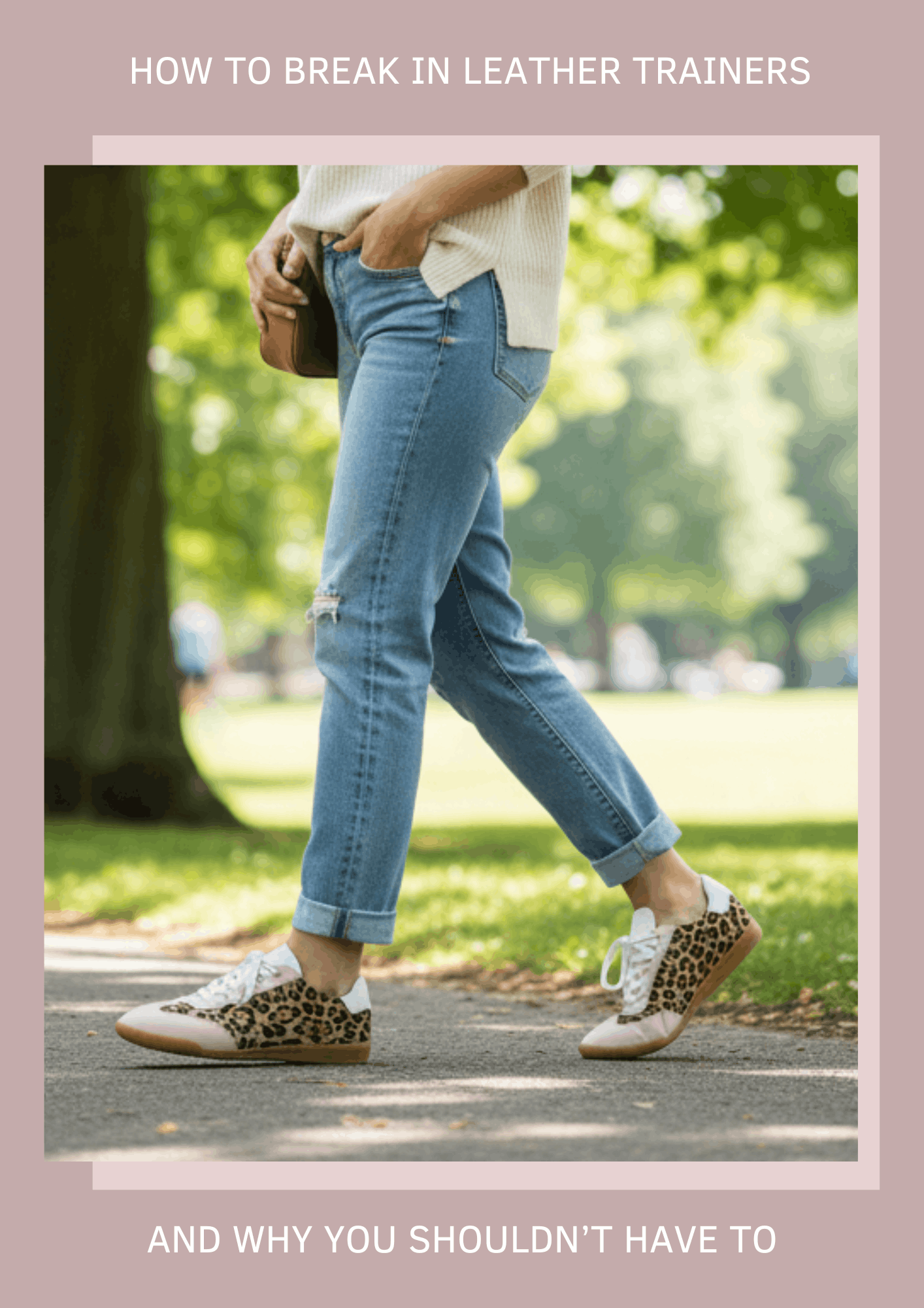 a woman walking through a sunlit park, wearing a cream sweater, light-wash jeans, and leopard-print trainers with pastel pink accents
