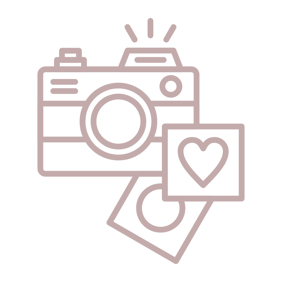 A minimalist line icon of a camera flashing with instant photos printed with a heart shape, in muted dusty pink.