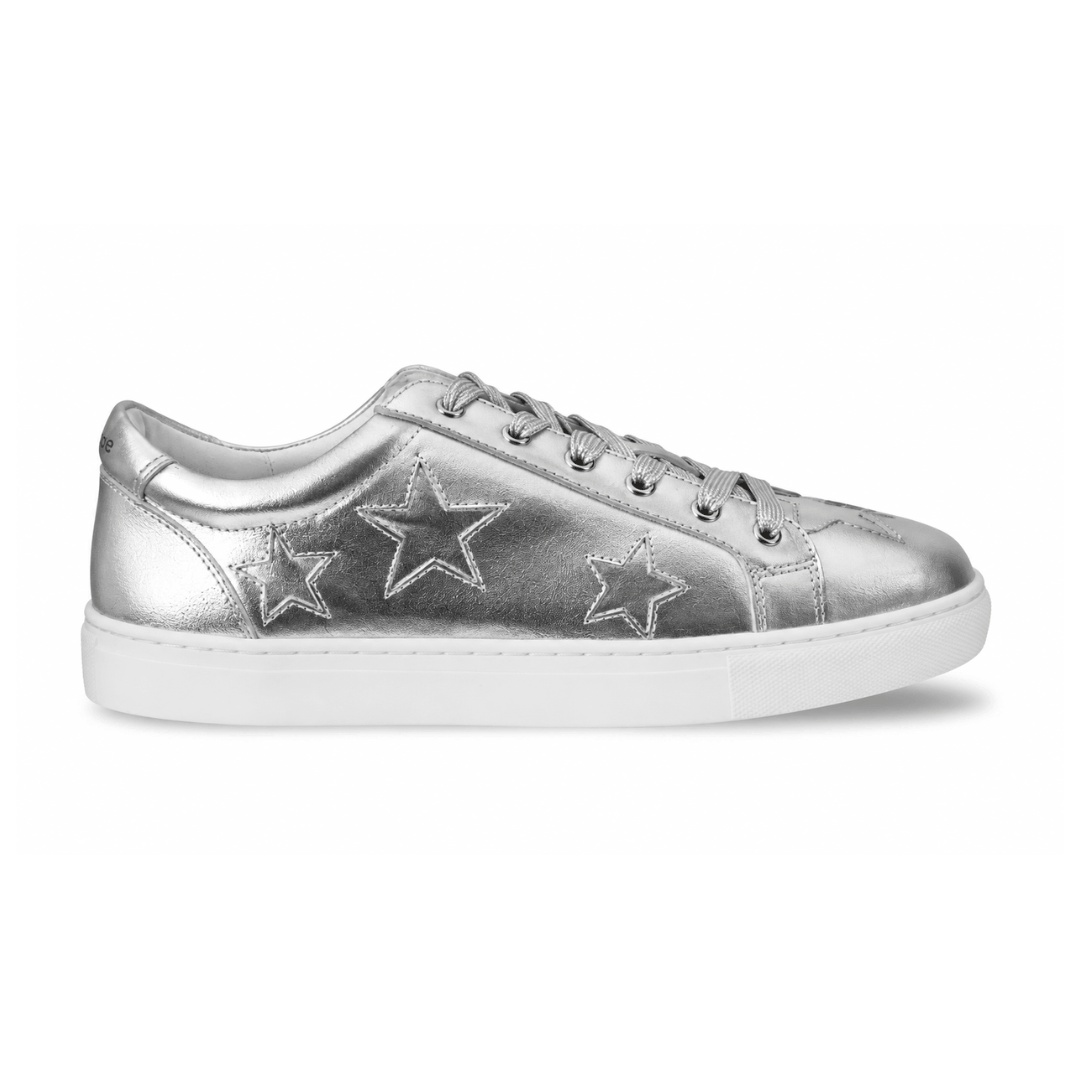 A metallic silver low-top sneaker with three embroidered star patches on the side, matching silver laces, and a thick white rubber sole, shown against a plain white background.