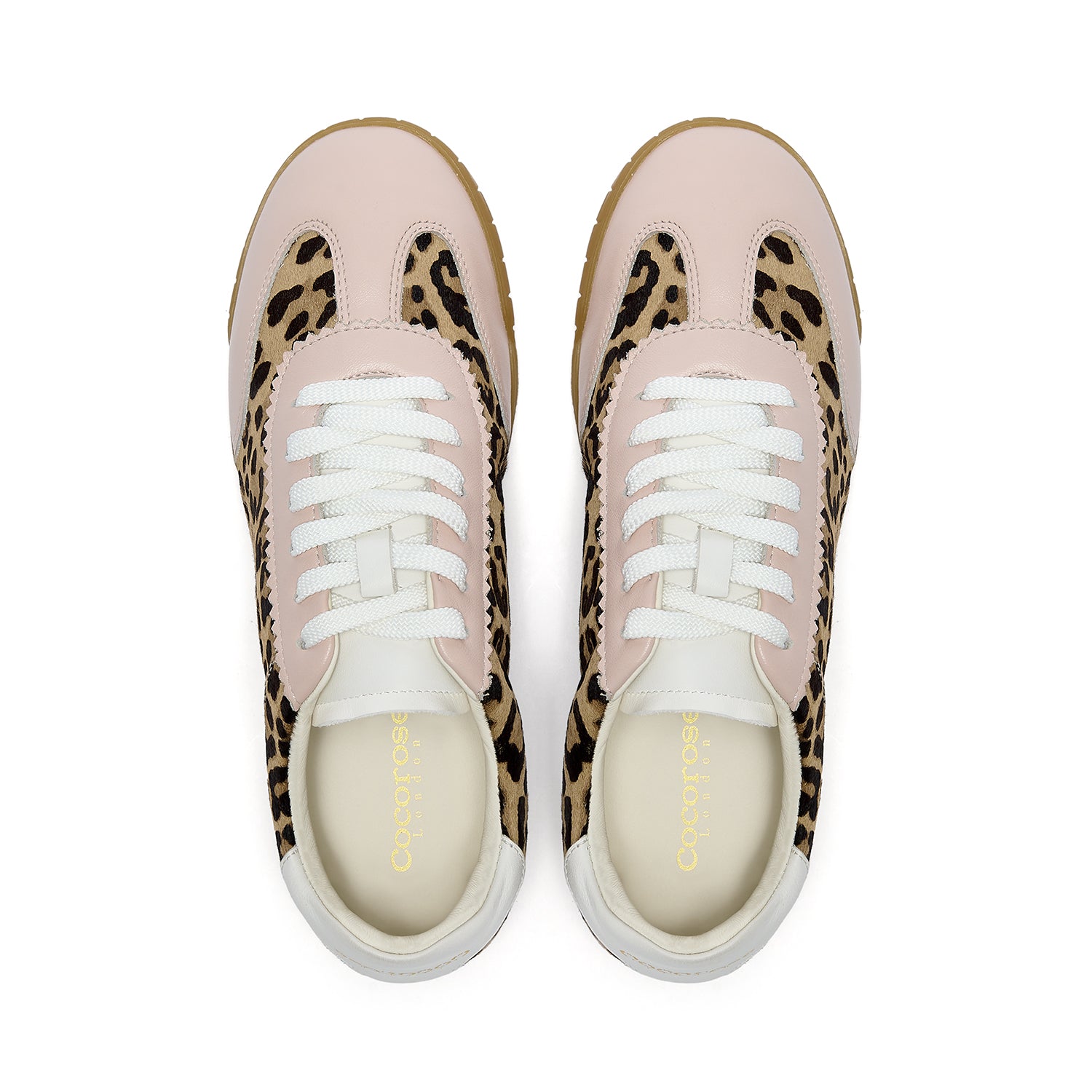 Birds eye view of Pastel Pink and Leopard print trainers on a white background
