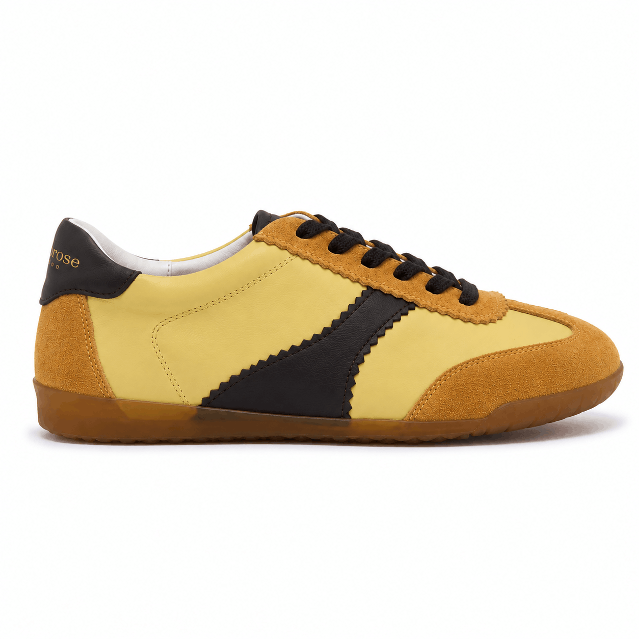 Yellow leather trainers with chocolate brown accents on a white background