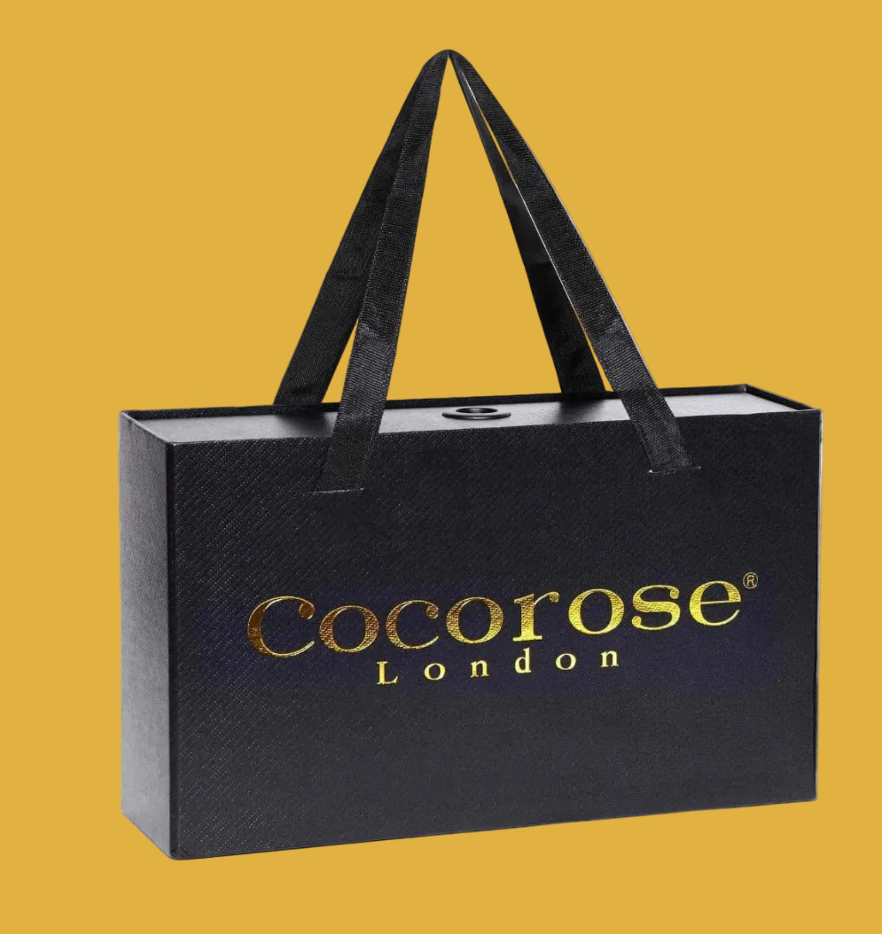 A presentation shoe box in black and gold, with handles by Cocorose London. Made from recycled materials.