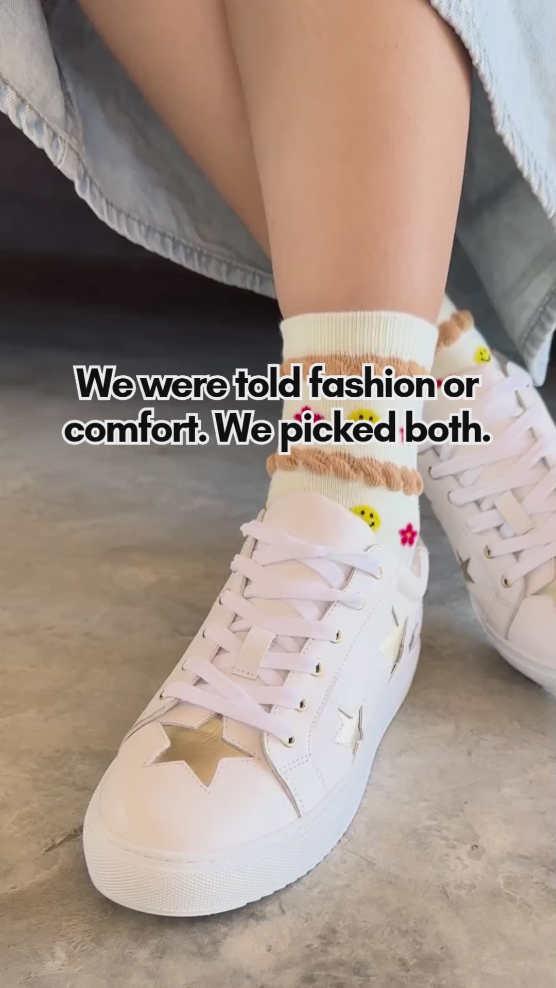 Short reel showing a person modeling white leather trainers with metallic gold star appliqués on the outer side and toe, styled with pattern socks and a denim skirt, with text overlay reading "We were told fashion or comfort. We picked both." and closing on the Cocorose London logo.