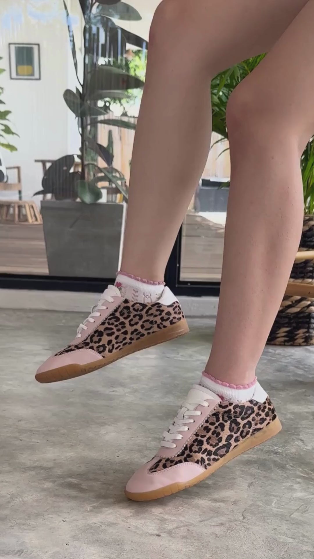 Video of girl wearing the Moorgate Leopard print trainers with pastel pink trim and moving her feet and legs